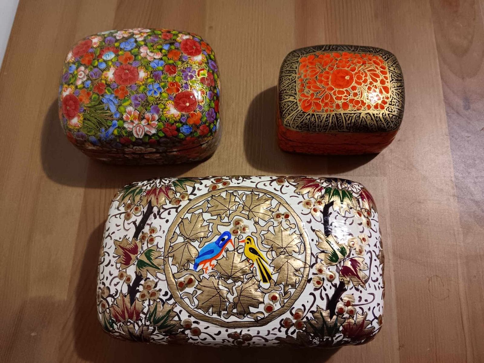 Three hand-painted Kashmiri papier-mâché boxes with flowers and birds